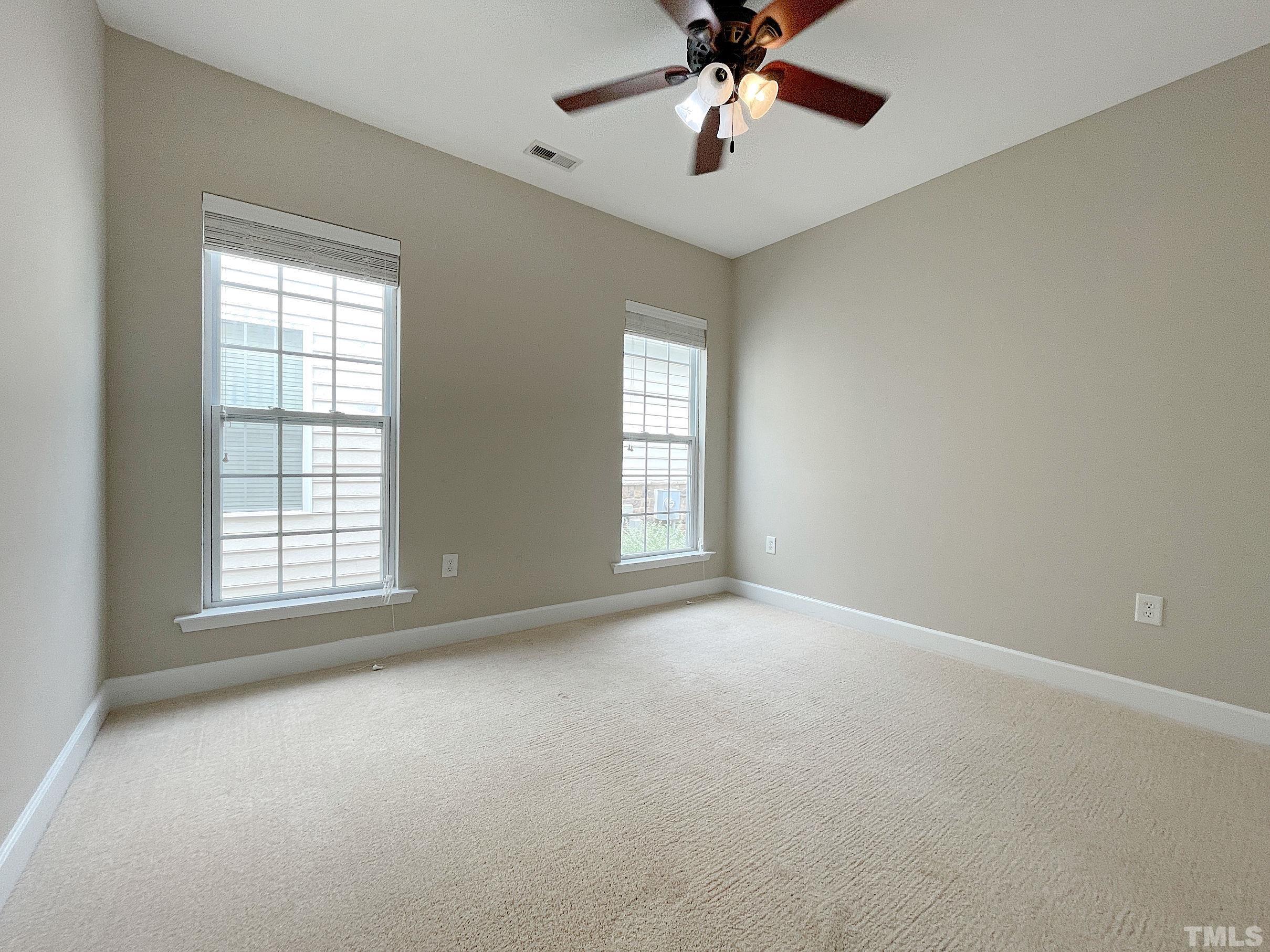 207 Beckingham Loop Cary, NC 27519 - Photo 20 of 40 an empty room with a window and a fan
