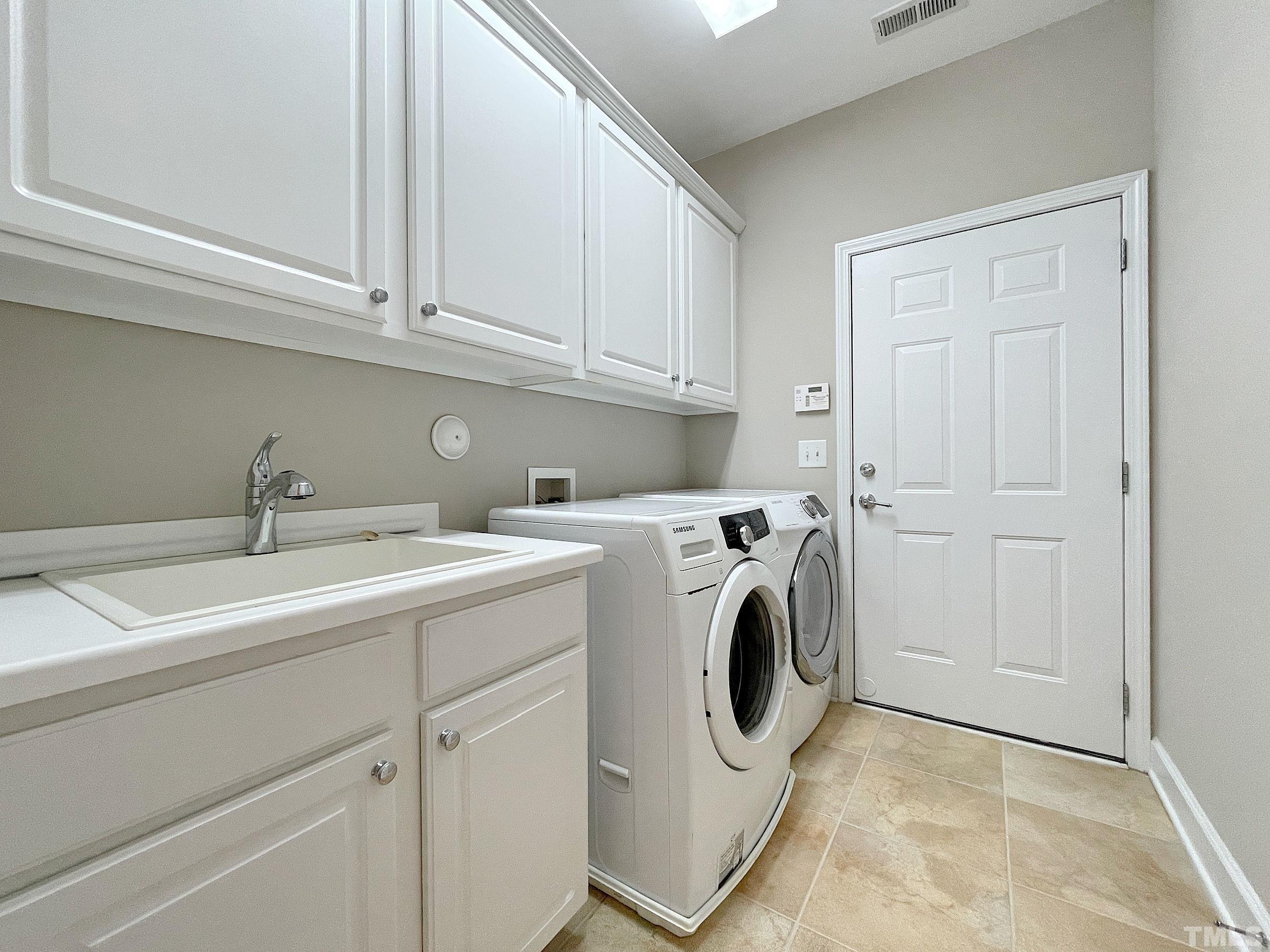 207 Beckingham Loop Cary, NC 27519 - Photo 22 of 40 a utility room with dryer and washer