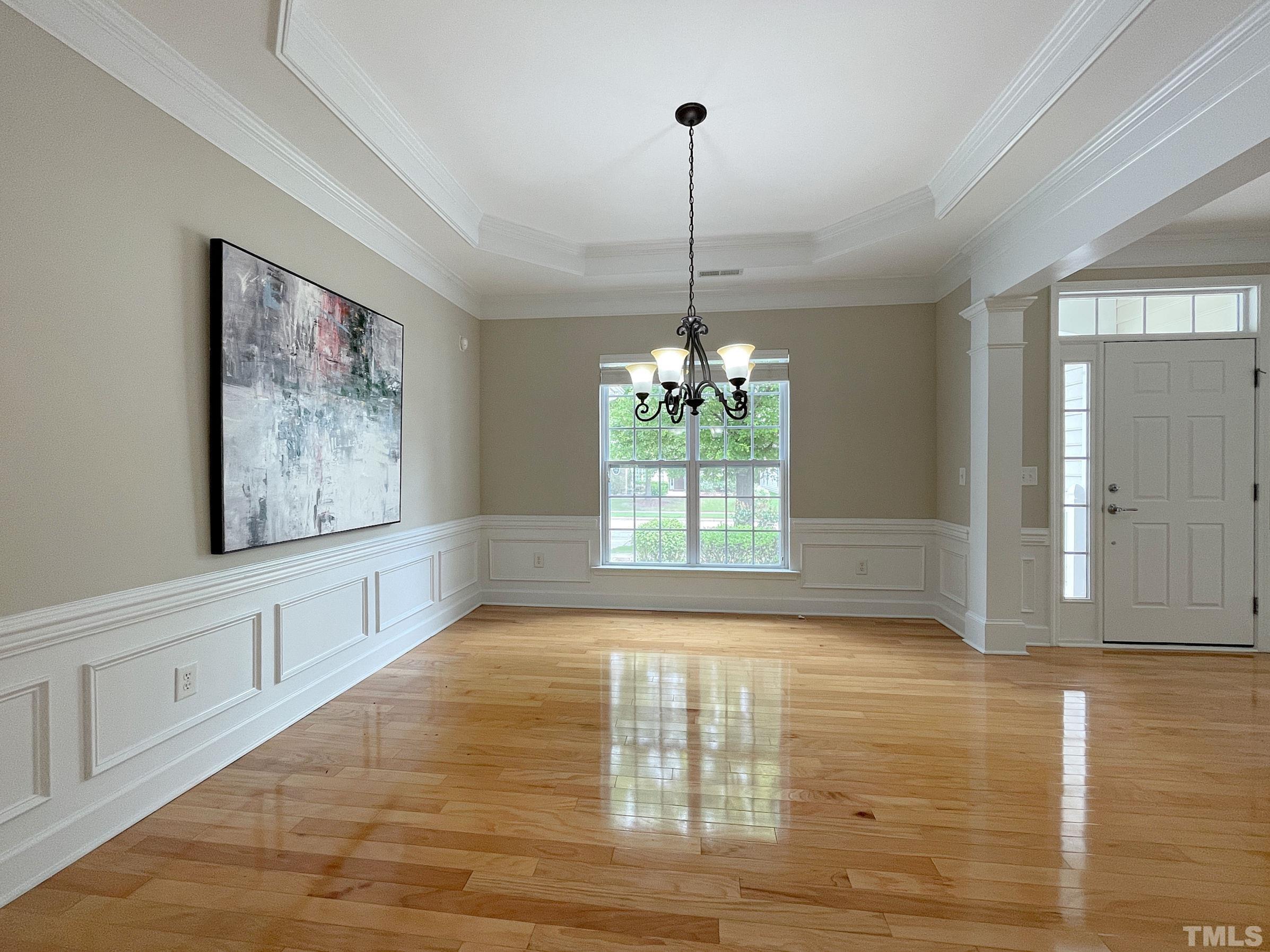 207 Beckingham Loop Cary, NC 27519 - Photo 4 of 40 a view of an empty room with window and wooden floor
