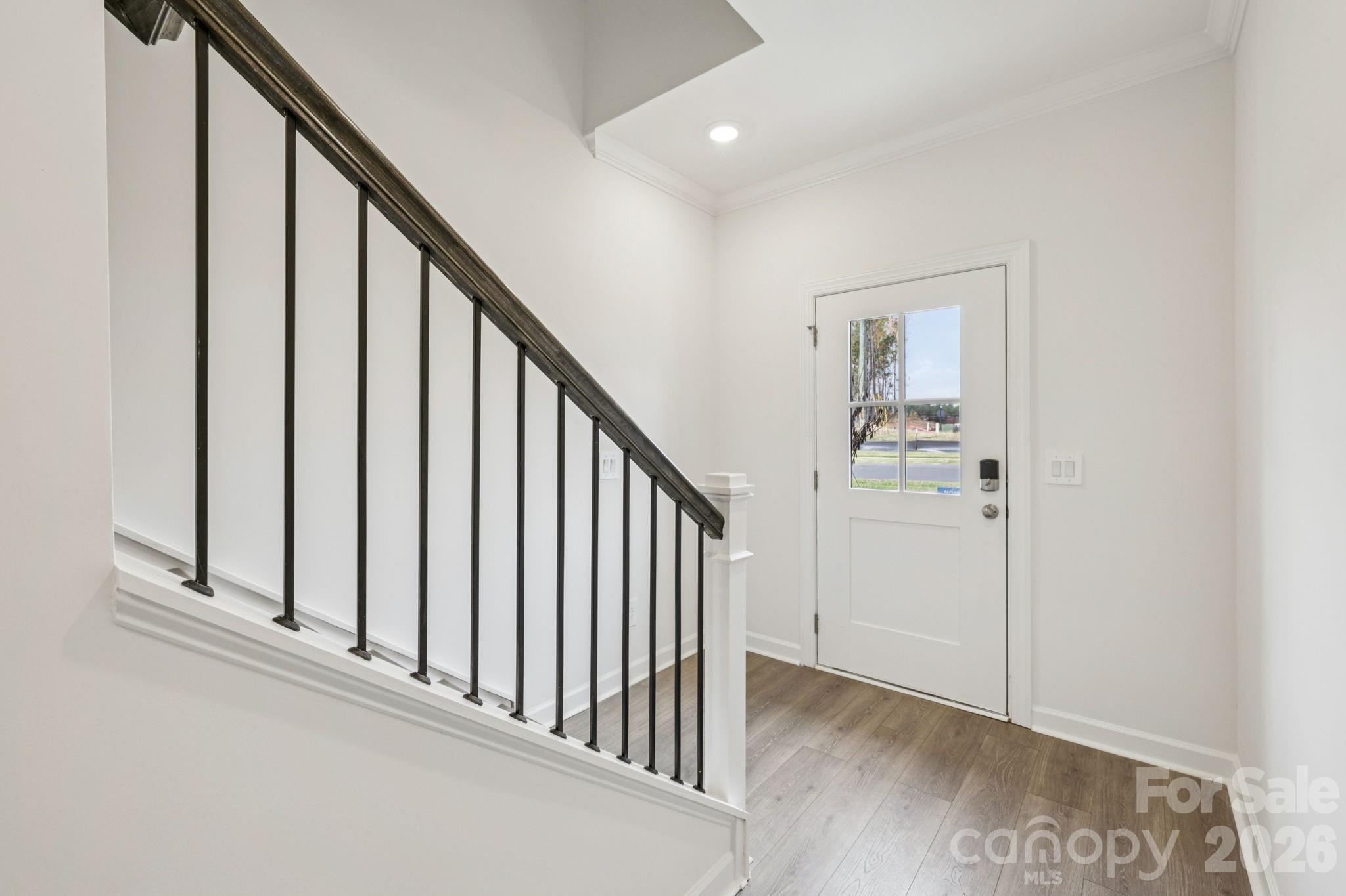 347 Golden Maple Court Fort Mill, SC 29708 - Photo 3 of 21 a view of a hallway with wooden floor and staircase