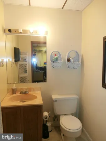 a bathroom with a granite countertop sink mirror vanity and toilet