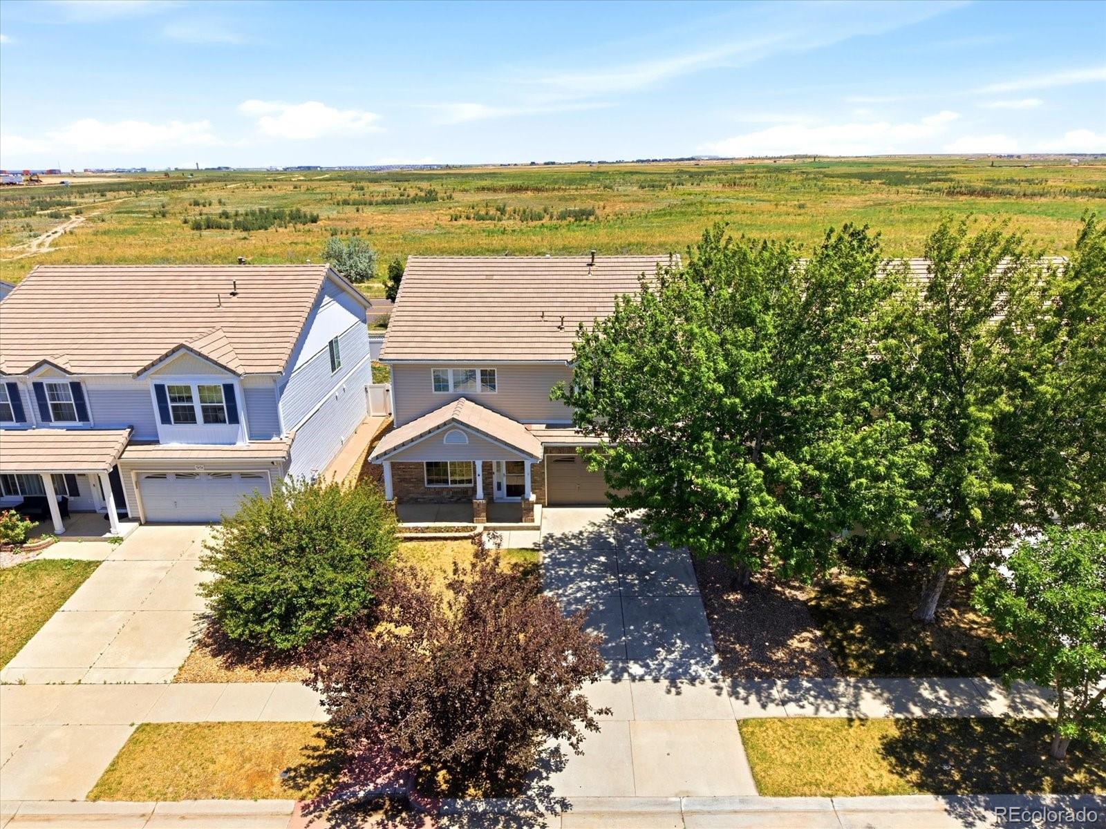 5444 Perth Court Denver, CO 80249 - Photo 46 of 46 a view of an ocean with a house in the background
