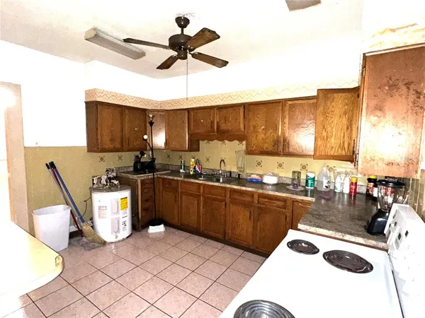 a kitchen with a sink a stove and chairs
