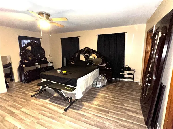 a living room with wooden floor furniture and a flat screen tv