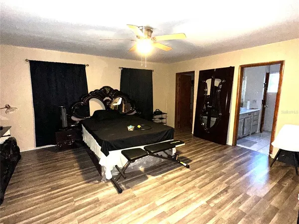 a living room with a table and a wooden floor