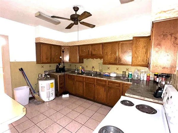 a kitchen with a sink a stove and chairs