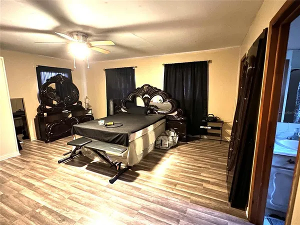 a room with gym equipment and wooden floor