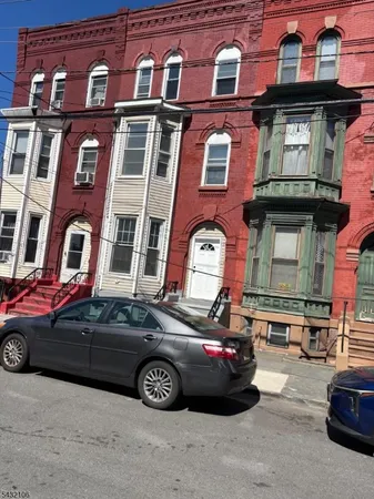 a front view of a house with parking space
