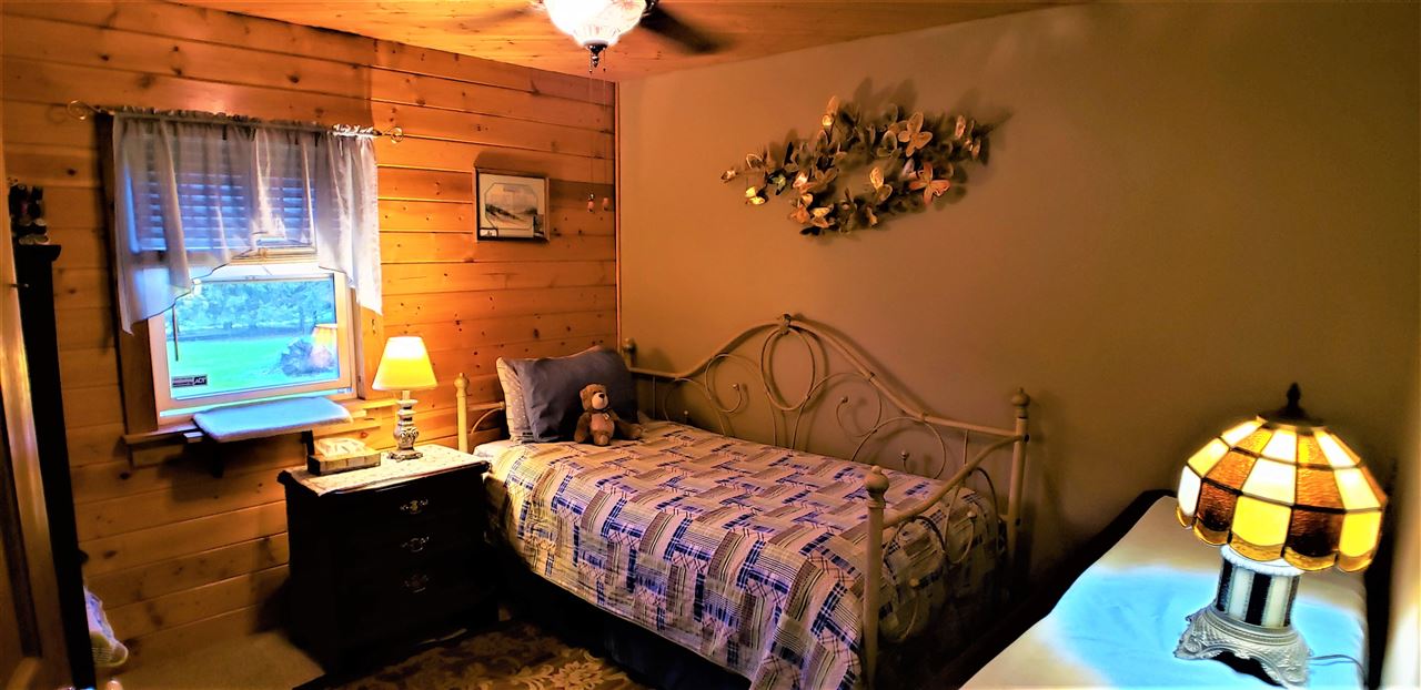 1573 Burkett Road Dixon, IL 61021 - Photo 14 of 25 a bedroom with a bed and wooden floor