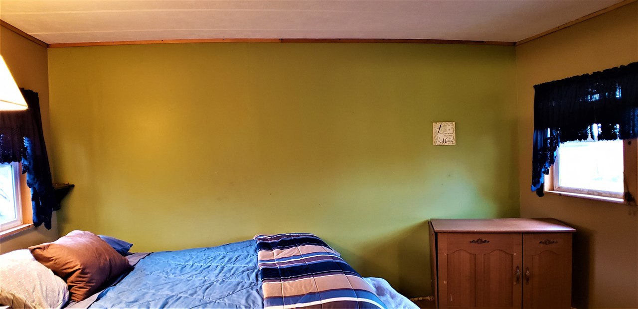 1573 Burkett Road Dixon, IL 61021 - Photo 17 of 25 a bedroom with a bed and wooden floor