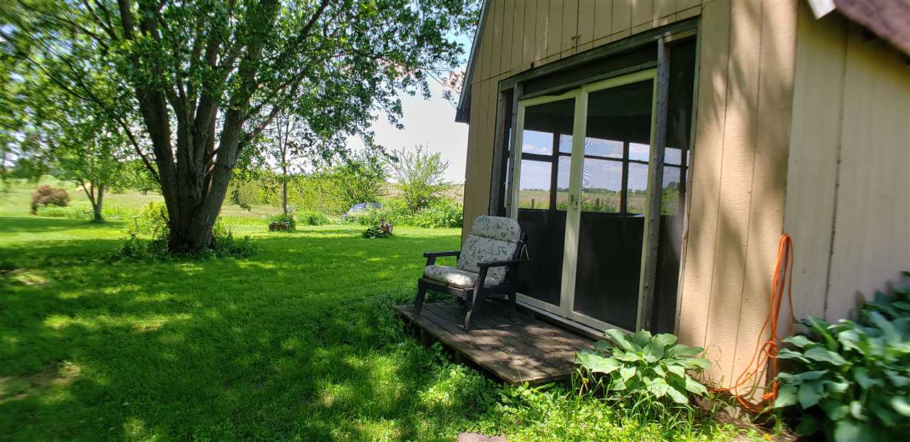 1573 Burkett Road Dixon, IL 61021 - Photo 21 of 25 a view of a porch with a bench and a yard