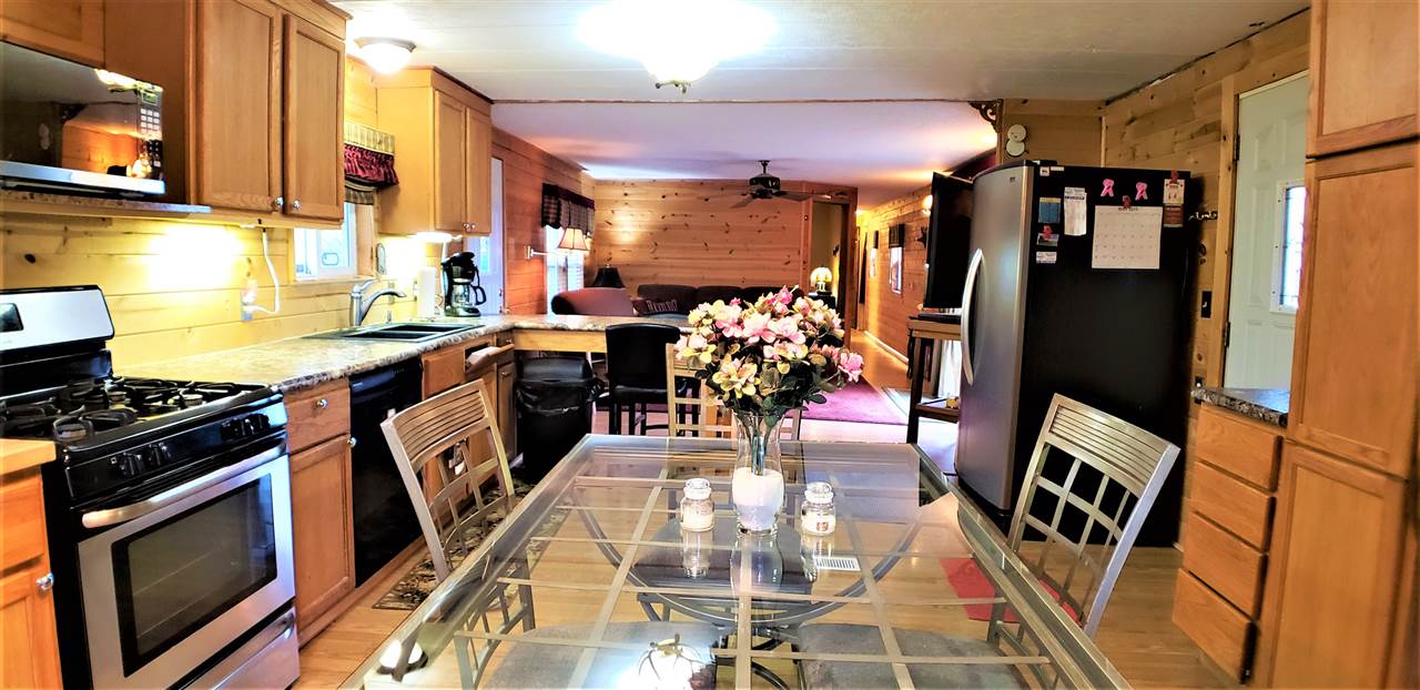 1573 Burkett Road Dixon, IL 61021 - Photo 7 of 25 a kitchen with stainless steel appliances granite countertop a stove a sink and a microwave