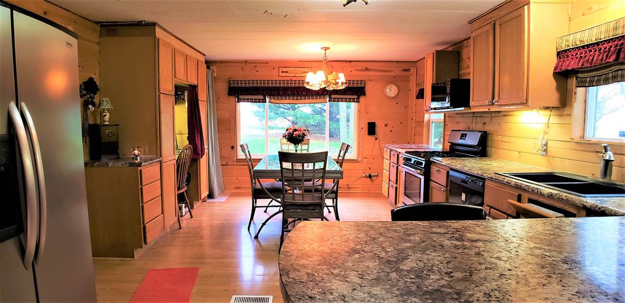 1573 Burkett Road Dixon, IL 61021 - Photo 8 of 25 a kitchen with stainless steel appliances granite countertop a refrigerator a stove and a wooden floors