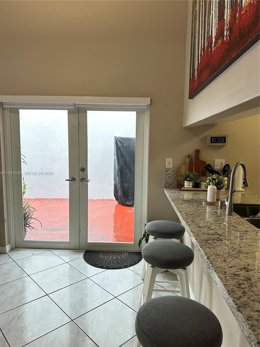 15318 Southwest 41st Terrace Miami, FL 33185 - Photo 11 of 30 a kitchen with stainless steel appliances kitchen island granite countertop a sink and a granite counter tops