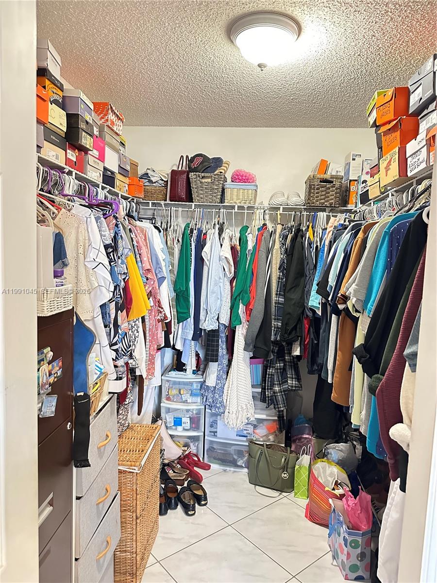 15318 Southwest 41st Terrace Miami, FL 33185 - Photo 15 of 30 a view of walk in closet with clothes