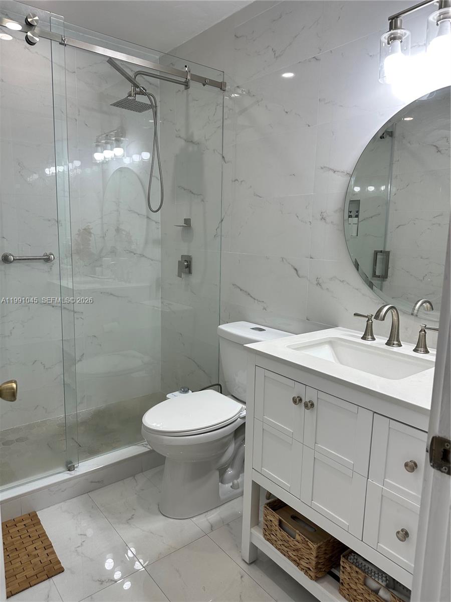 15318 Southwest 41st Terrace Miami, FL 33185 - Photo 16 of 30 a bathroom with a sink toilet and shower