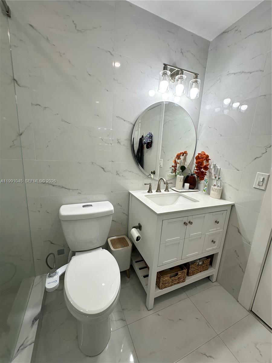 15318 Southwest 41st Terrace Miami, FL 33185 - Photo 18 of 30 a bathroom with a sink mirror and toilet
