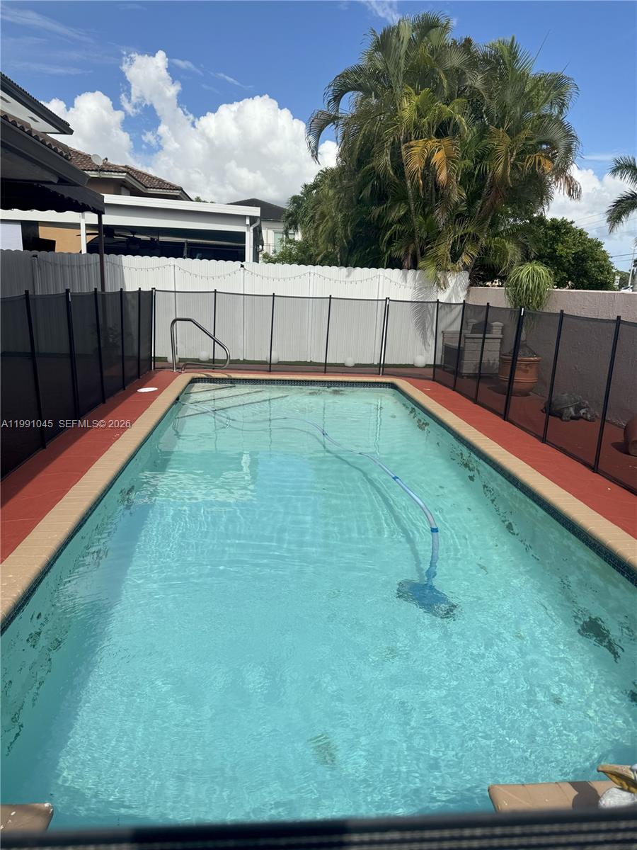 15318 Southwest 41st Terrace Miami, FL 33185 - Photo 25 of 30 a view of a backyard with a small pool
