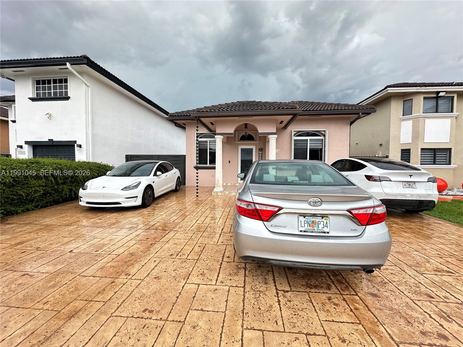 15318 Southwest 41st Terrace Miami, FL 33185 - Photo 4 of 30 a car parked on the side of the road