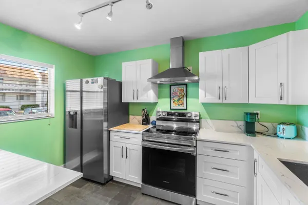 a kitchen with a sink cabinets and window