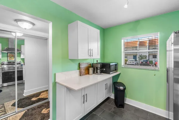 a kitchen with a sink a stove and cabinets