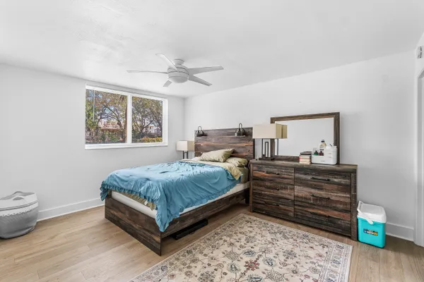a bedroom with a bed and wooden floor