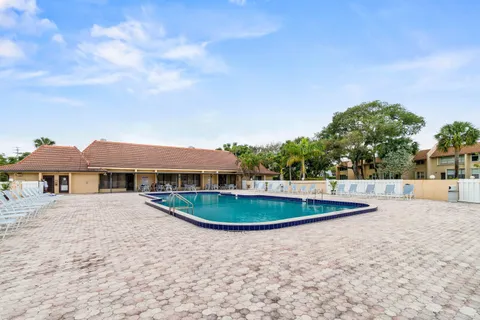 an aerial view of an buildings and swimming pool