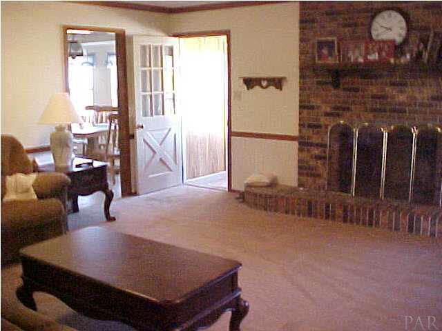 beautiful family room with fireplace and entrances to kitchen