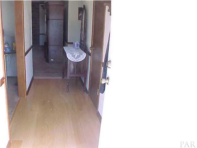 pergo flooring in foyer with living room to the left,