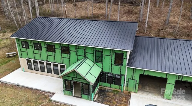 a view of a backyard with a deck and wooden fence