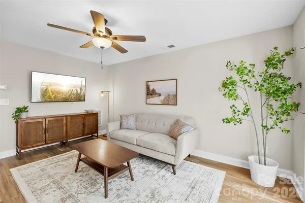 a living room with furniture and a potted plant