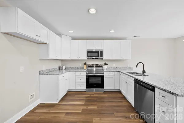 a kitchen with granite countertop stainless steel appliances and sink