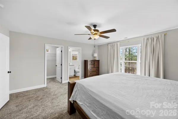 a bedroom with a large bed closet and a window