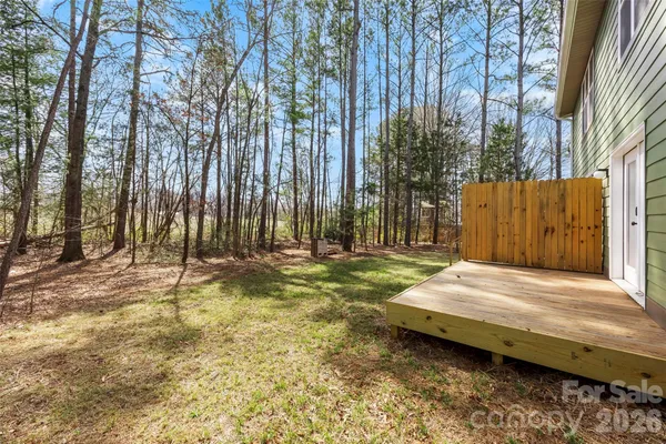 a wooden bench sitting in the middle of a yard