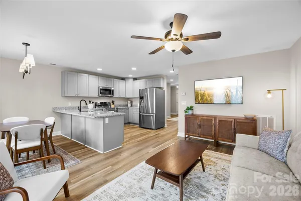 a living room with furniture and kitchen view