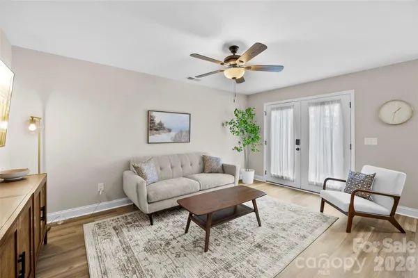 a living room with furniture and a wooden floor