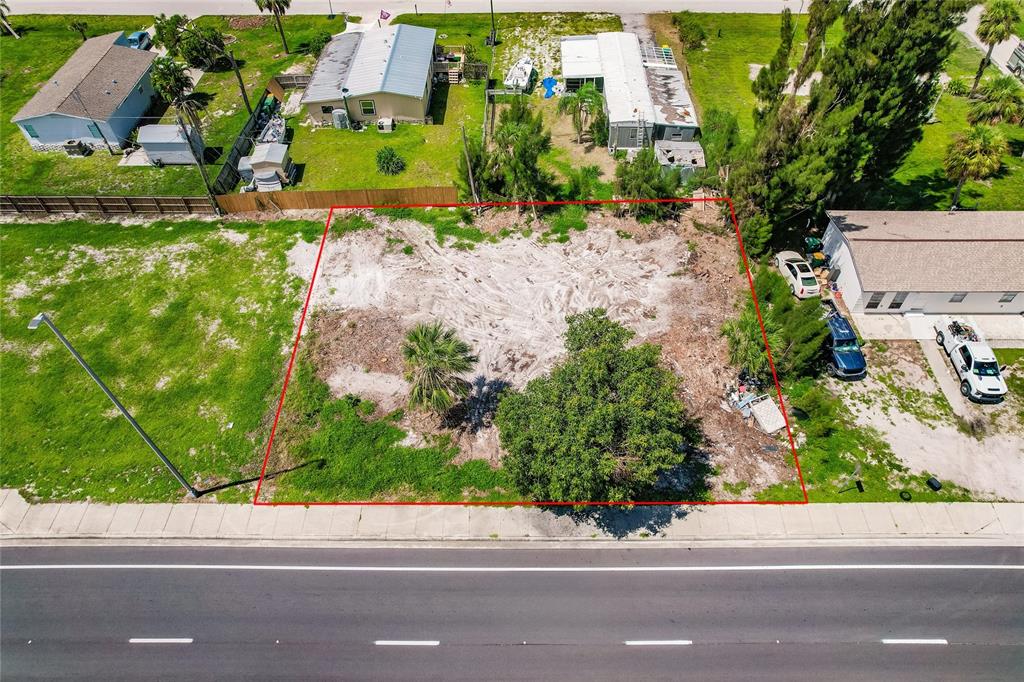 3220 Placida Road Englewood, FL 34224 - Photo 8 of 8 an aerial view of a house with a yard and a garden