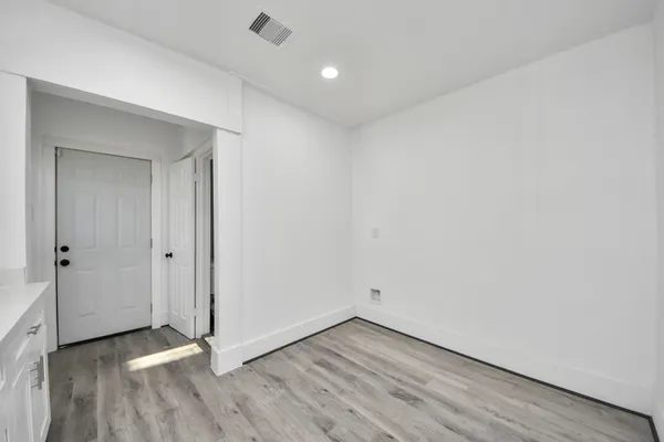 a view of an empty room and wooden floor