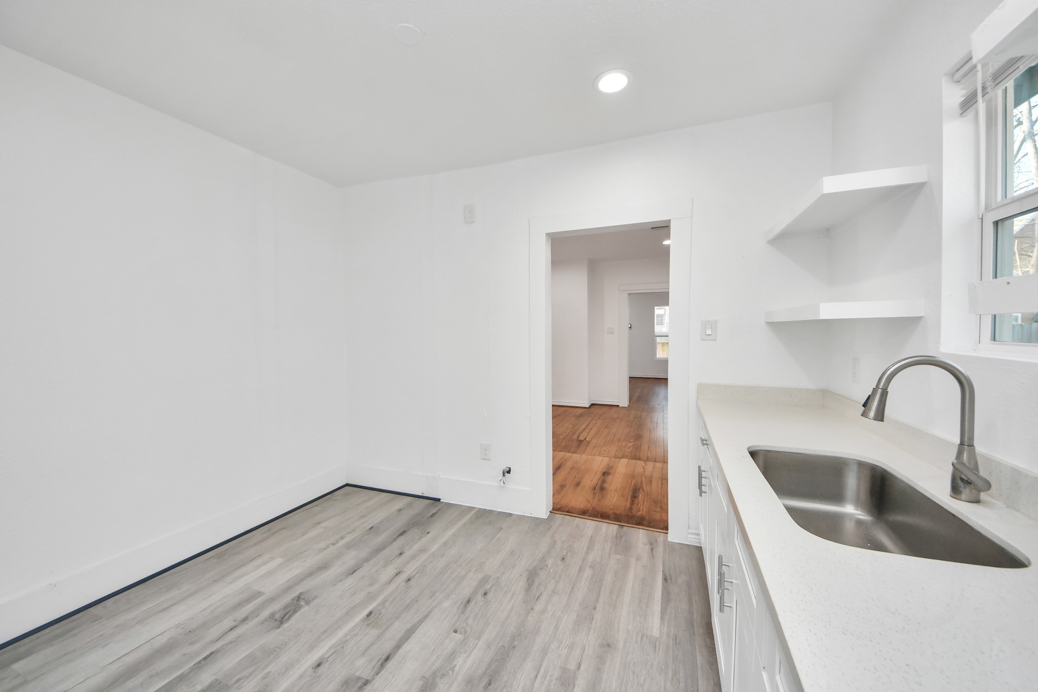 3423 Beulah Street Houston, TX 77004 - Photo 13 of 36 a kitchen with a sink cabinets and wooden floor