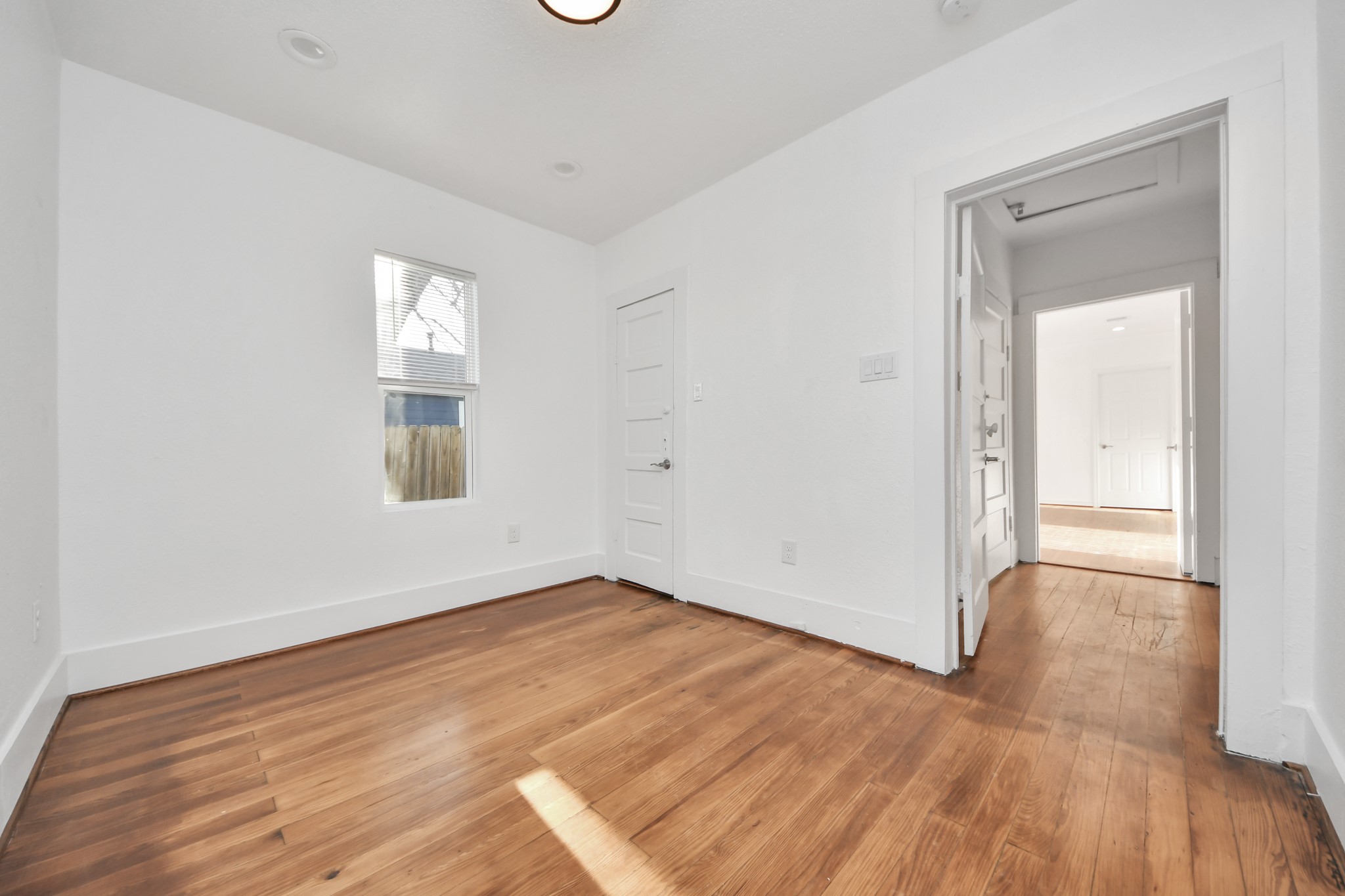 3423 Beulah Street Houston, TX 77004 - Photo 18 of 36 an empty room with wooden floor and windows