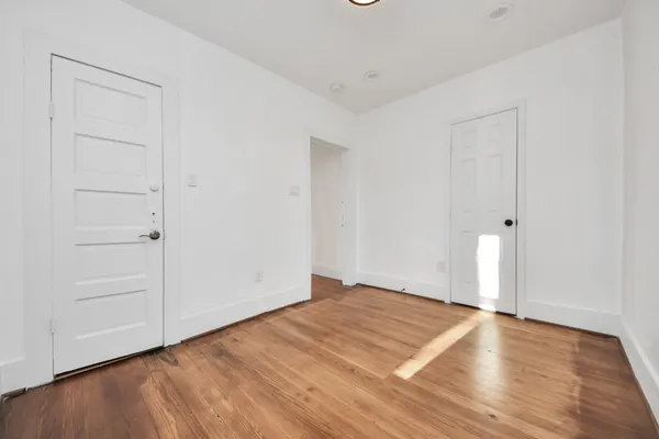 an empty room with wooden floor
