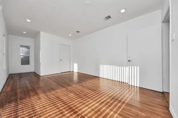 a view of a room with wooden floor and staircase