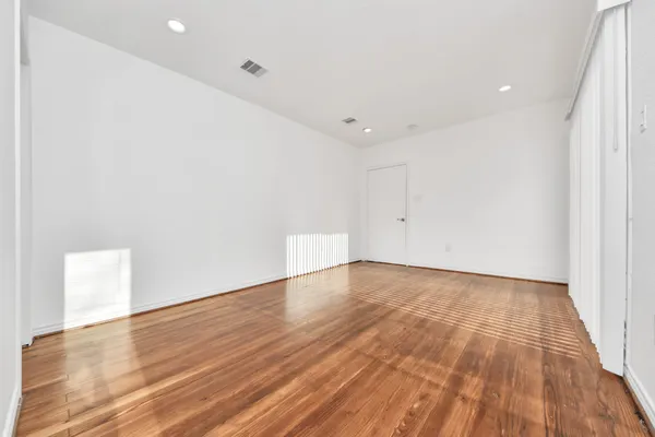 an empty room with wooden floor
