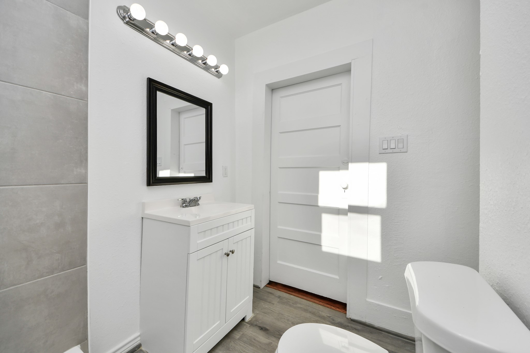 3423 Beulah Street Houston, TX 77004 - Photo 25 of 36 a bathroom with a toilet sink a mirror and window
