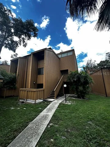 a view of a house with backyard and sitting area