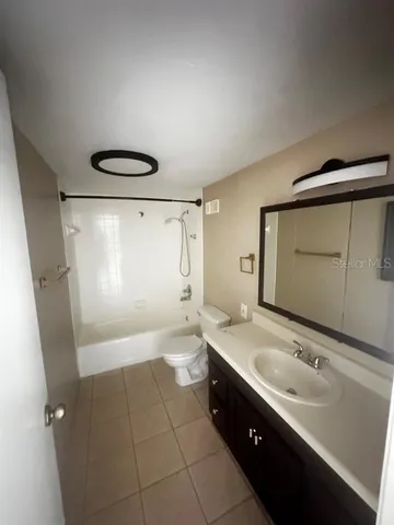 a bathroom with a double vanity sink a mirror and a shower
