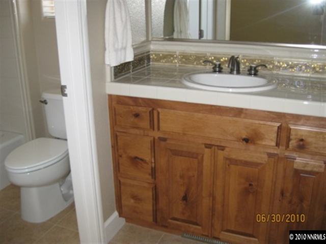 8549 Timaru Trail Reno, NV 89523 - Photo 5 of 9 a bathroom with a sink a toilet and shower