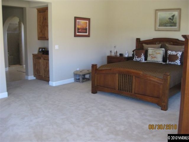 8549 Timaru Trail Reno, NV 89523 - Photo 6 of 9 a bed room with a bed and a chair