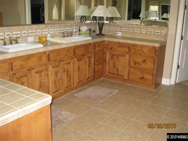 8549 Timaru Trail Reno, NV 89523 - Photo 7 of 9 a bathroom with a sink and a mirror
