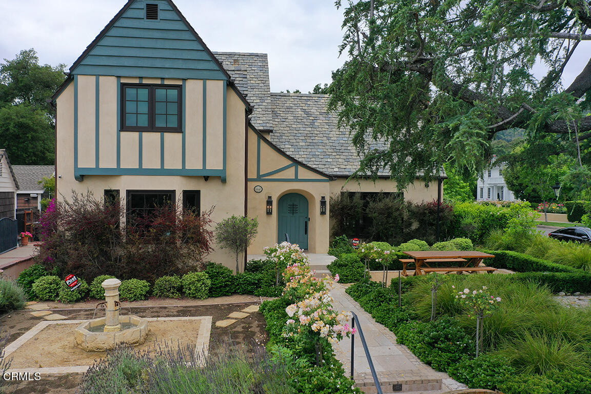 a front view of a house with garden